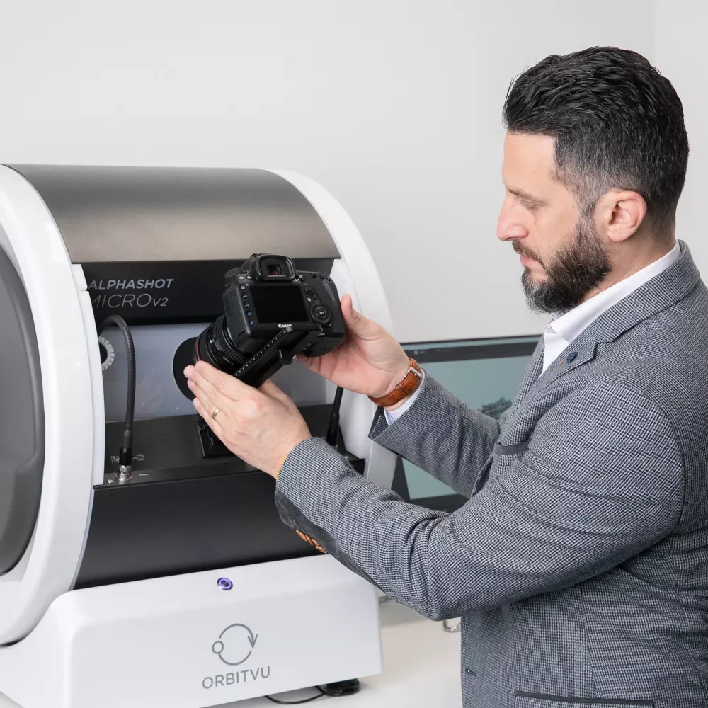 Mężczyzna mocujący kamerę do Orbitvu Alphashot Micro V2